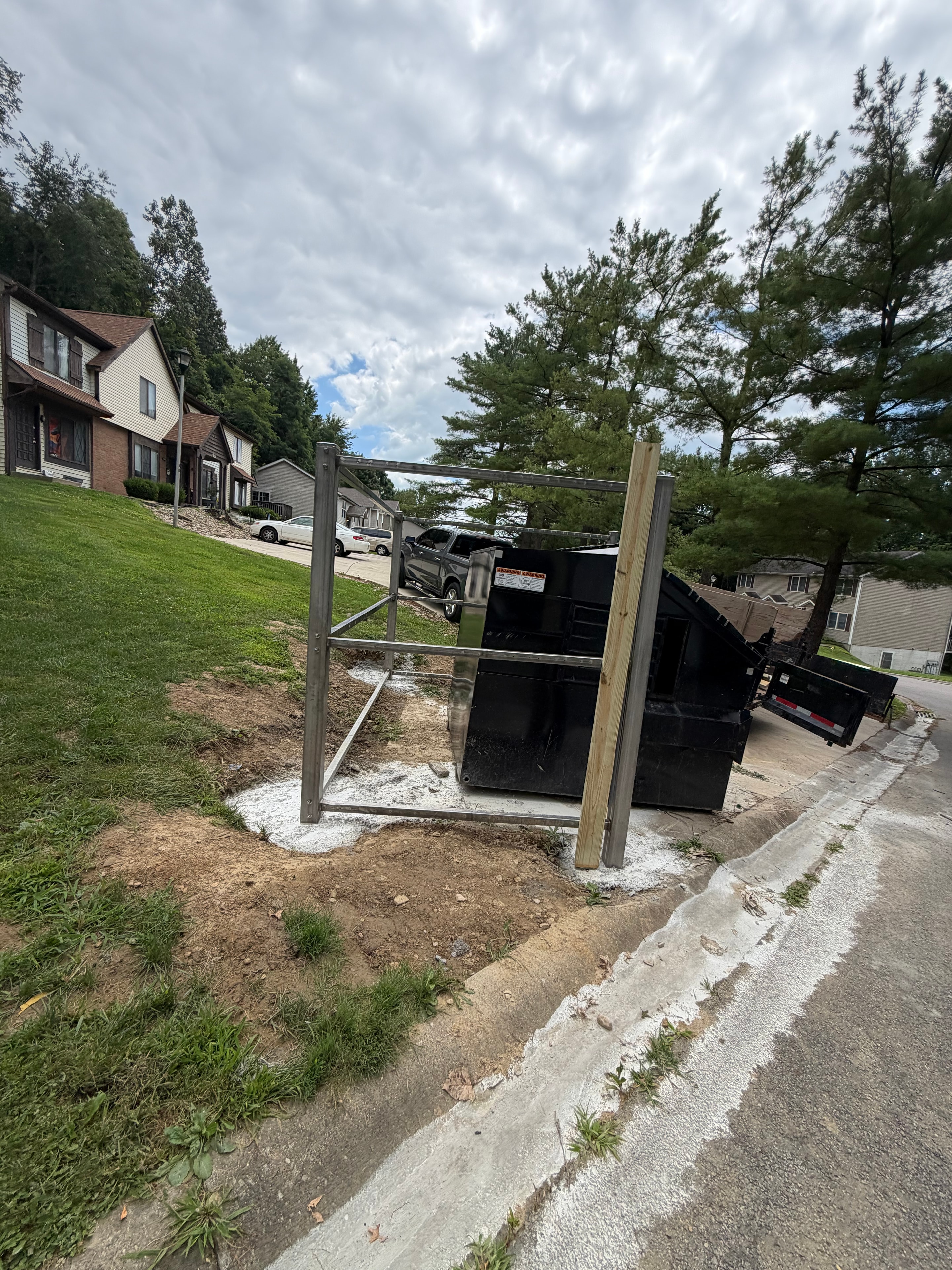 Trash enclosure open frame showing steel post and rebar
